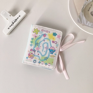 Detail of cute M5 cartoon notebook with pink ribbon bow and creative doodle art cover
