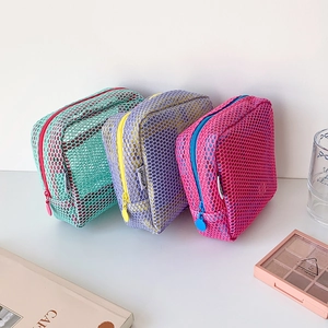 Three-piece colorful mesh makeup bags in mint green, lavender, and peach pink with contrast zippers