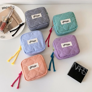 Quilted checkerboard square cosmetic pouches in five colors with woven zipper pulls