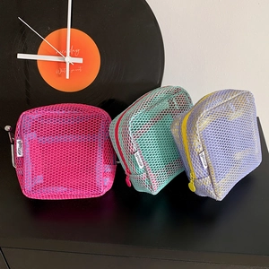Detailed view of colorful mesh storage bags with zipper closure and brand label