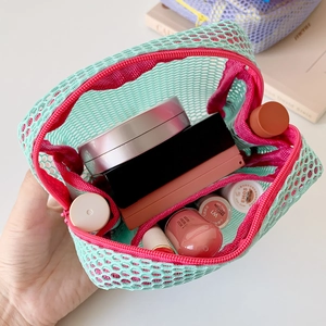 Portable mesh makeup bag with mint green grid and pink zipper showing cosmetics inside