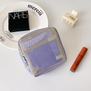 Detailed close-up of a double-layer mesh makeup bag with a stylish color-contrast design
