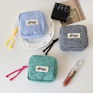 Compact square checkered quilted storage pouches in blue, black, and green colors