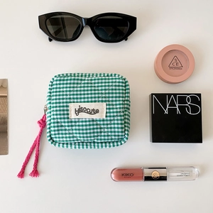 Green and white checkered quilted makeup bag with zipper and hisocute fabric label