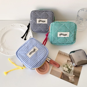 Quilted checkered mini pouch set in black, blue and green with a woven zipper pull cord