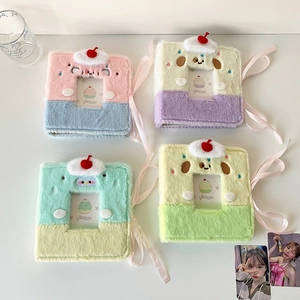 Detail view of plush A7 binder albums with cherry charms and ribbon ties for photo cards