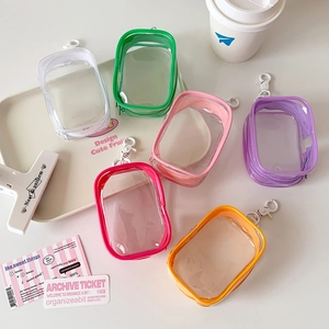 Close-up of colorful mini transparent PVC bags with hooks and zippers in assorted colors