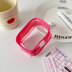 Macro view of rose pink transparent PVC storage bag with zipper and white hook