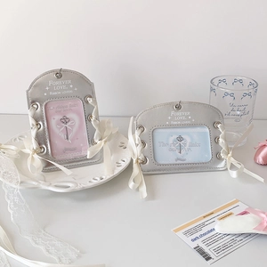 Detail of silver PU photo card holders with elegant white silk bows and side ribbon lacing