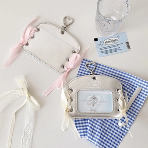 Detail of ballet style PU leather card holder with ribbon bow and heart metal clasp