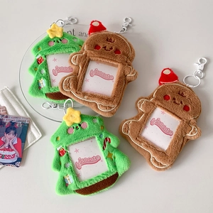 Detail of plush Christmas tree and gingerbread man card holders with metal clasps