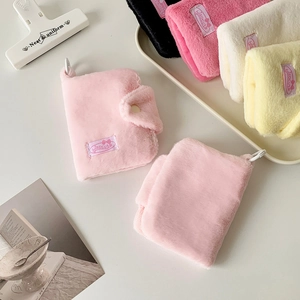 Detail of plush coin purses in multiple colors with snap button and carry loop