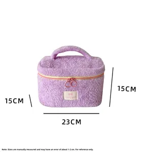 Detail view of purple plush makeup bag with top handle and 23x15x15cm size markers