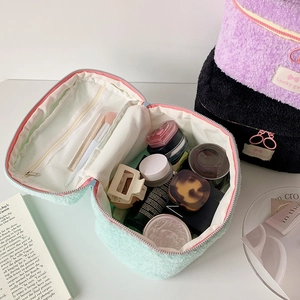 Fleece cosmetic bag set in mint green, purple and black with spacious interior