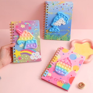Detailed view of spiral notebooks featuring unicorn and ice cream silicone pop toys