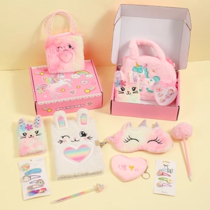 Detailed plush unicorn gift set including notebook, eye mask and bag in pink tones