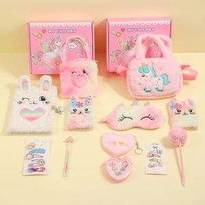 Flat lay of pink unicorn plush stationery set with furry notebook, bags and accessories