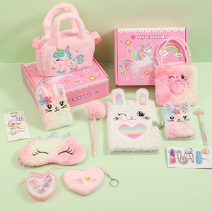 Flat lay of unicorn plush stationery set with bag, notebook, and accessories in a gift box