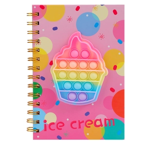 Detail of pink coil notebook featuring a rainbow silicone pop-it cupcake design