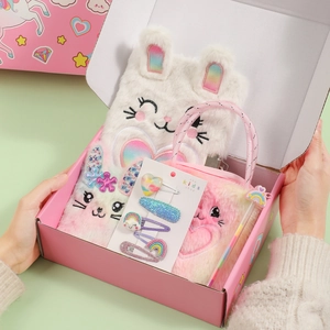 Detail of plush cat notebooks and sequin hair clips in a unicorn gift set for girls