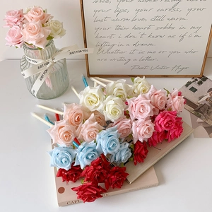 Elegant artificial rose flower ballpoint pens in multi-color on a desk for romantic gift