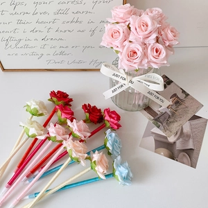 Detail of silk-wrapped ballpoint pens with realistic rose floral tops in various colors
