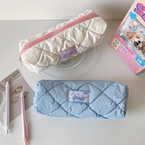 Quilted pouch with zipper and cartoon dog patch in white and blue soft fabric