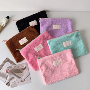 Colorful plush makeup bags with ring zippers and lucky gate label on white background
