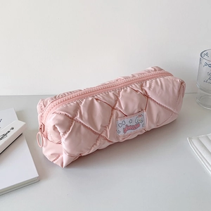 Detail of pink quilted nylon pencil case featuring a fluffy texture and cartoon patch