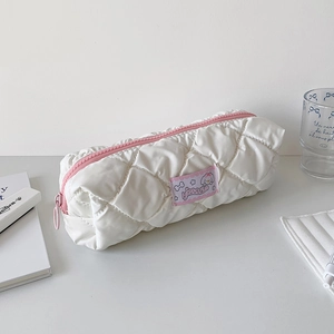 Detail of white quilted waterproof pouch with pink zipper and cute cartoon character patch