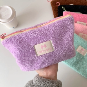 Minimalist purple plush cosmetic bag with a zipper and fluffy texture for stationery