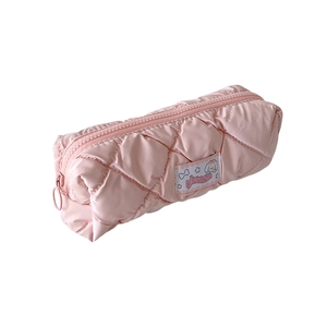 Pink quilted pencil case with cute dog patch and zipper closure on a white background