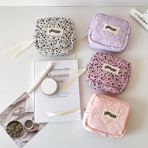 Quilted cosmetic bags in leopard and polka dot prints with decorative white ribbons