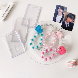 Transparent acrylic heart keychain card holders in pink and teal for photo cards