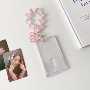 Detail of clear acrylic photocard holder with pink heart beads and a lovely heart pendant