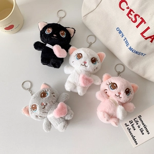 Macro detail of plush cat keychains in four colors with soft fur and metal clips