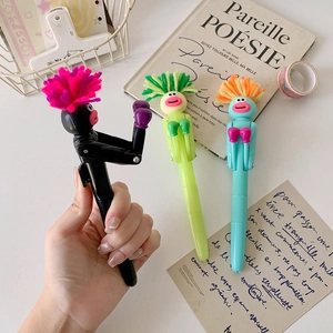 Close-up of funny boxing pens with fuzzy hair and punch function on a white desk