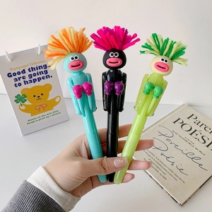 Detail of creative cartoon boxing ballpoint pens with fluffy hair in blue, green, and black