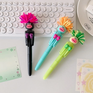 Detailed close-up of colorful cartoon boxing pens with fuzzy hair on a desk