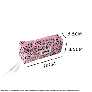 Detail view of pink quilted pencil case with ink splatter pattern showing 20x8.5x6.5cm size
