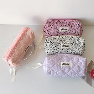 Chic ink-splatter and quilted pencil pouches with ribbons in soft pastel colors