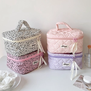Quilted floral and polka dot makeup bags with top handles in four stylish patterns