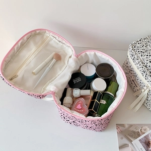 Pink and white polka dot large cosmetic bag with internal mesh pocket and handle