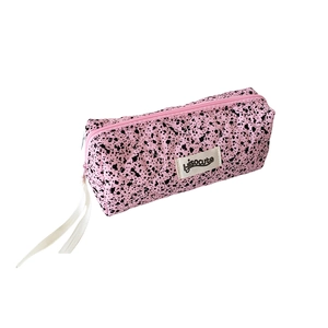 Pink quilted ink-splatter stationery bag with ribbon zipper and brand label on white background