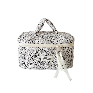 Quilted ink splash cosmetic bag with top handle and Hisocute tag on white background