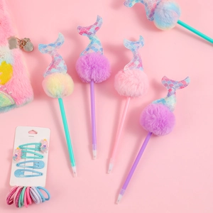 Detail of mermaid pens with colorful pom-poms and glitter tails on pink background