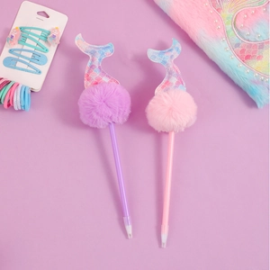 Detail of mermaid ballpoint pens with fluffy pom poms and glitter fishtail toppers