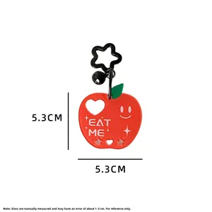 Detailed view of red apple keychain with Eat Me print and black star clip, 5.3cm size