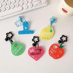 Cute macaron acrylic star and heart keychains on keyboard background for girls bags