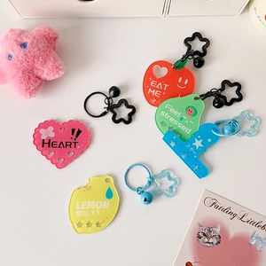 Close-up of colorful acrylic fruit pendants with metal star clasps and cute bells